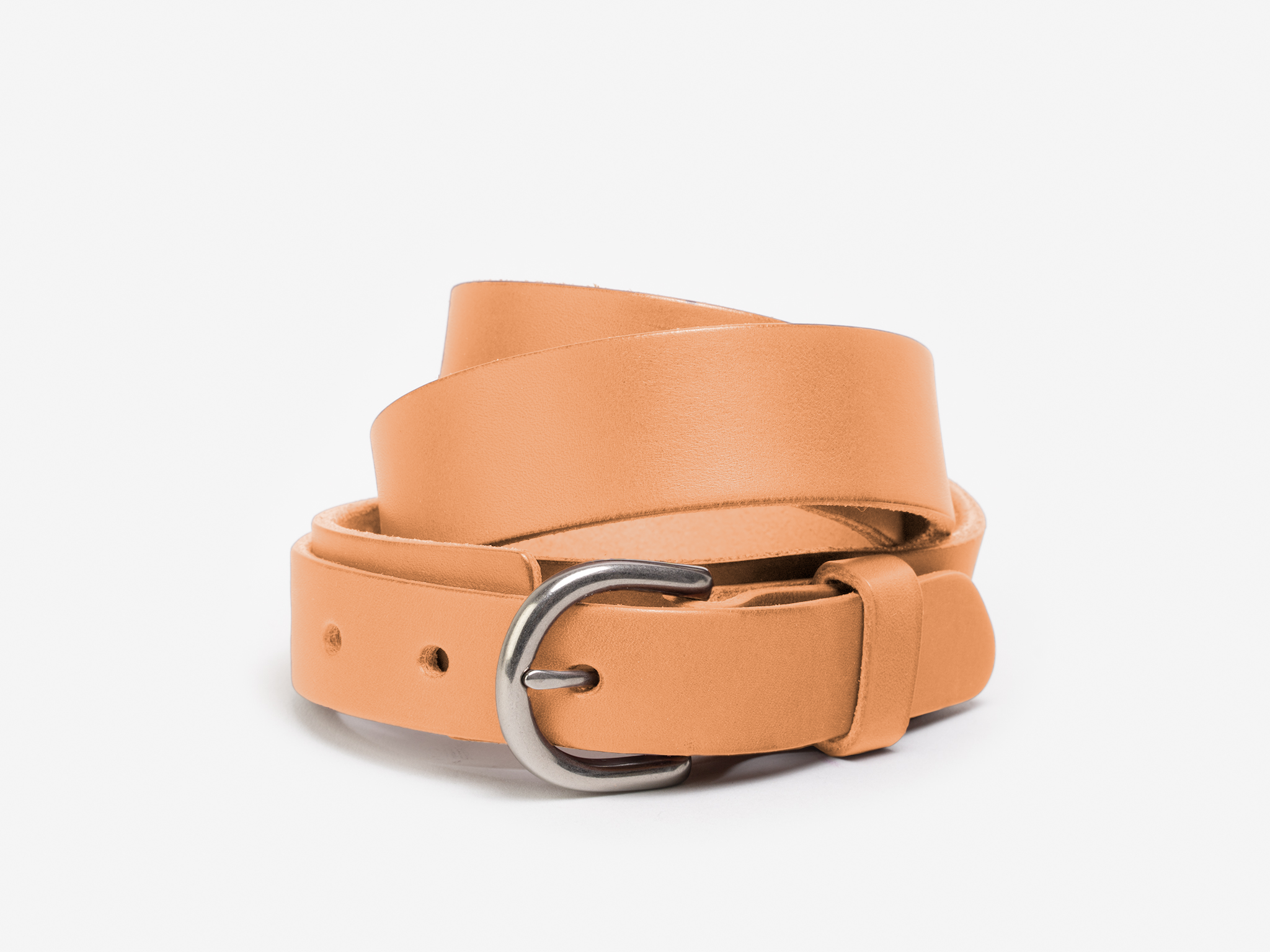 A tan leather belt with a silver buckle, coiled neatly on a white background.